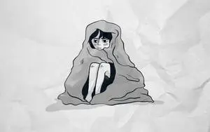 Young Woman Feeling Anxious Wrapped in Blanket