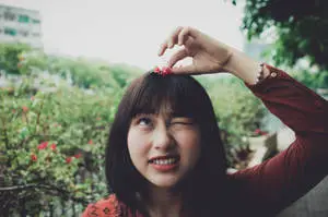 Asian Woman Playing With A Flower
