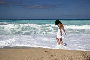 Beach Girl Walking Into Waves