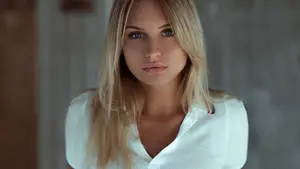 Dazzling blonde woman elegantly dressed in a white shirt