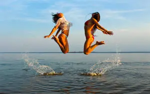 Bikini Girl Jumping On Sea 