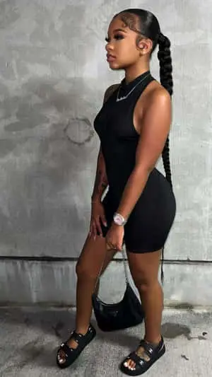 a woman in a black sleeveless romper