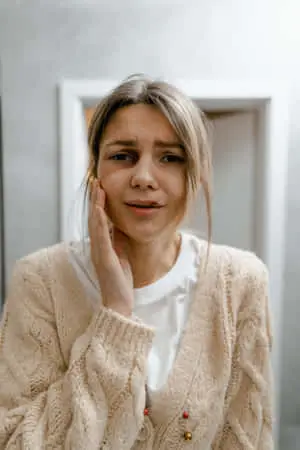 Bruised Girl Holding Cheek