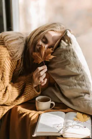 Cozy Lady Sniffing Autumn Leaf Aesthetic