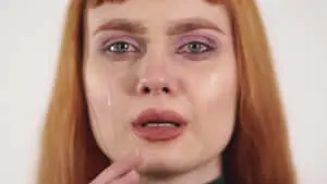 a woman with red hair is crying