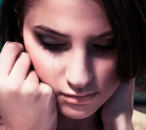 a woman with a tear on her face