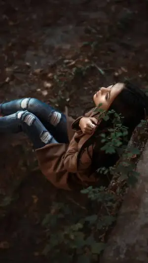 Dramatic Girl Sitting In Forest Alone