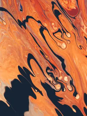 an orange and black liquid painting on a black background