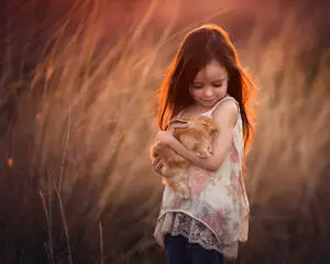 Girl Child Holding A Rabbit
