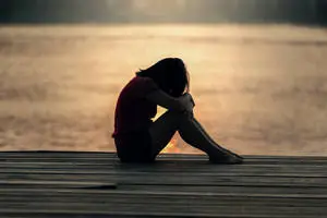 Serenity in Solitude: A Lone Girl Reflecting On a Dock