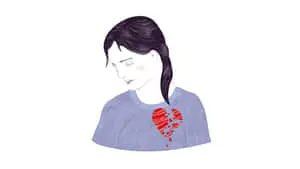 a woman with a broken heart in her shirt