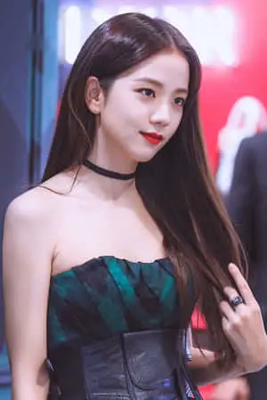 a young woman in a black dress posing for a photo