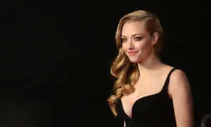 a woman in a black dress posing for the camera