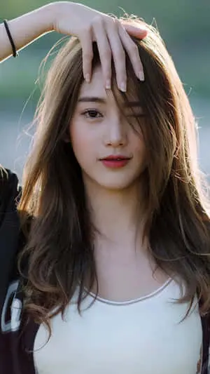  Caption: Charming Asian Model Playfully Winking in a Portrait Photograph 