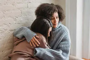 Two Sad Women Hugging Picture