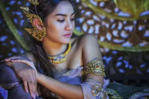 Traditional Thai Woman Adorned in Gold Accessories