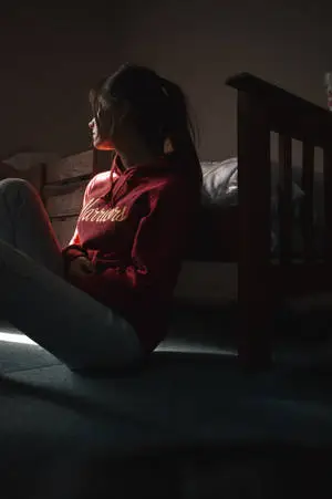 Woman Sitting Alone Near Bed
