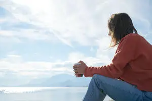 Serene Woman Enjoying Coffee in Solitude