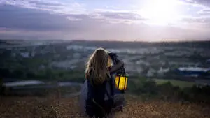 Woman With Lamp Sitting Alone